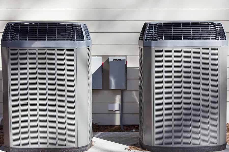 Two outdoor heat pump units needing repair