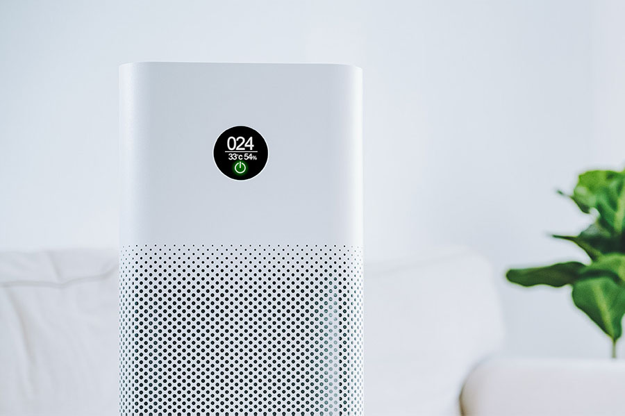 Home air purifier displaying an air quality reading of 024 in a living room