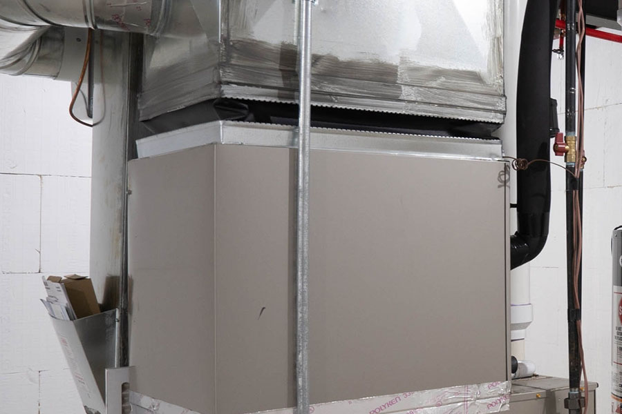 Air handler installed in a basement below sheet metal ductwork