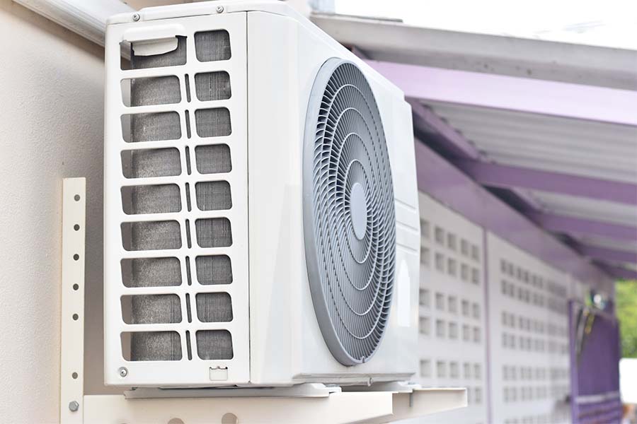 Mini split outdoor condenser mounted on a wall bracket